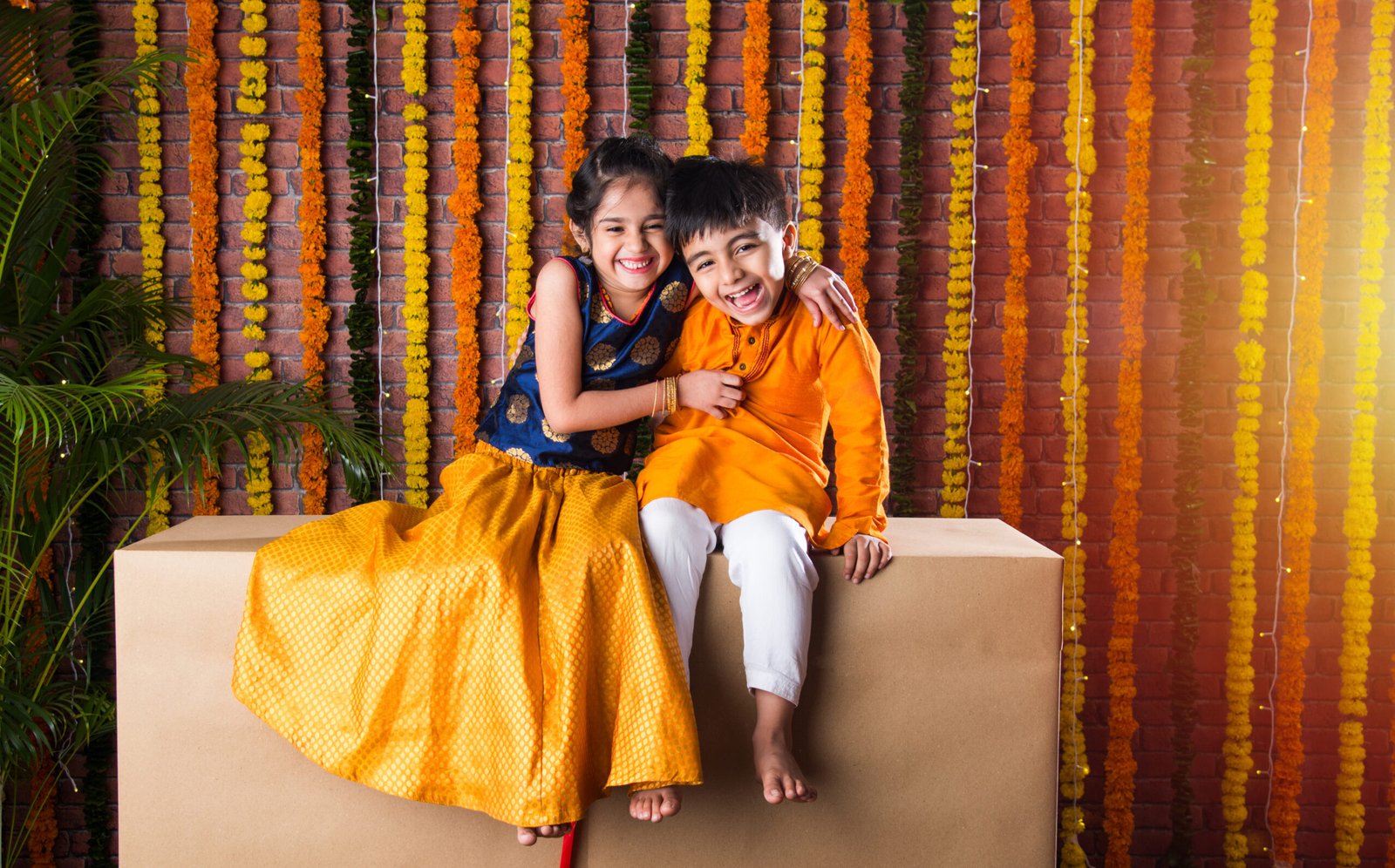 Two joyful children in vibrant traditional Indian ethnic wear laughing together